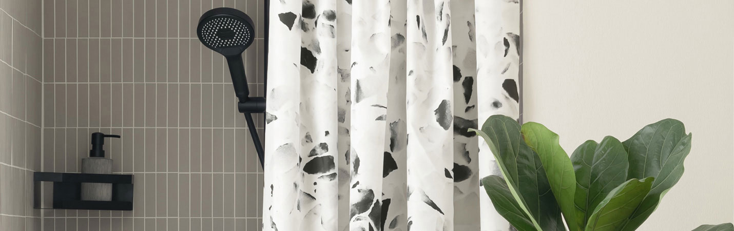 Textil-Duschvorhang Wenko Tosi mit schwarz-weiss Terrazzo-Muster aus recyceltem Polyester in moderner Dusche